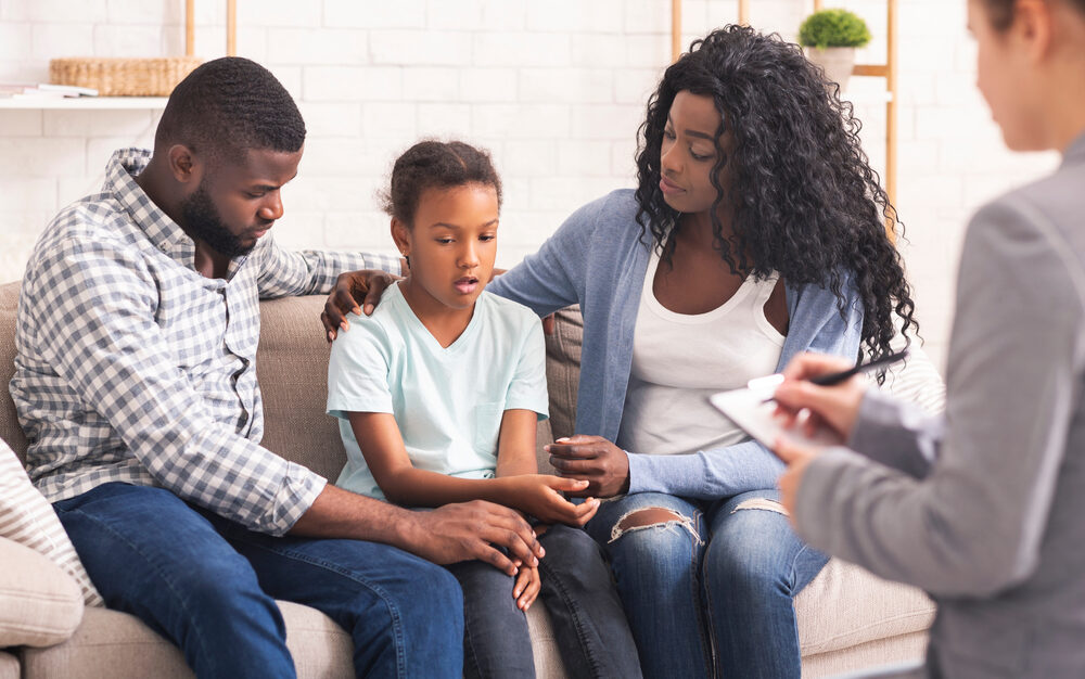 girl and her parents in therapy session